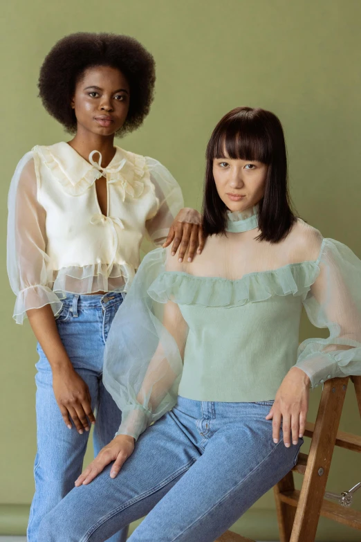 two women standing next to each other in front of a green wall, an album cover, trending on cg society, renaissance, cream colored blouse, transparent background, puff sleeves, pale blue