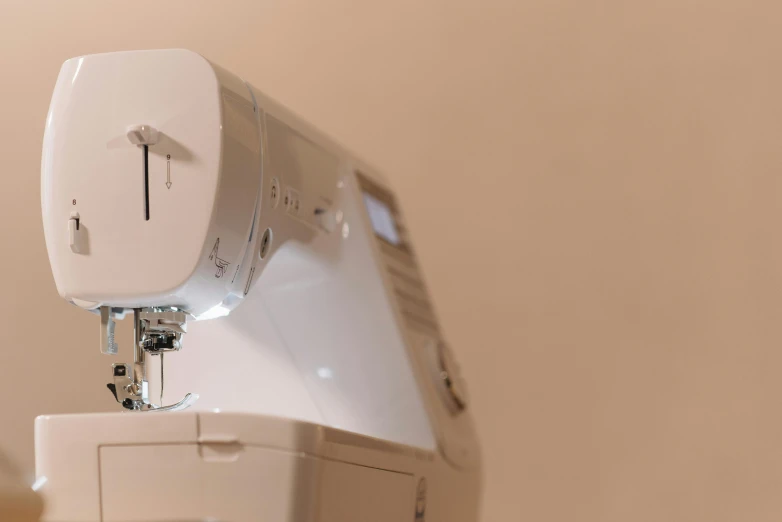 a white sewing machine sitting on top of a table, a picture, up close, digital image, profile image, thumbnail