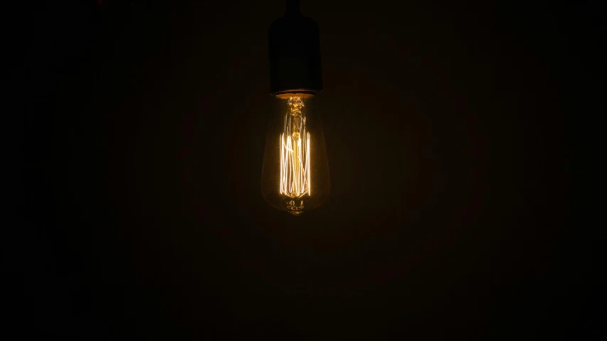 a light bulb lit up in the dark, inspired by Elsa Bleda, light and space, brown