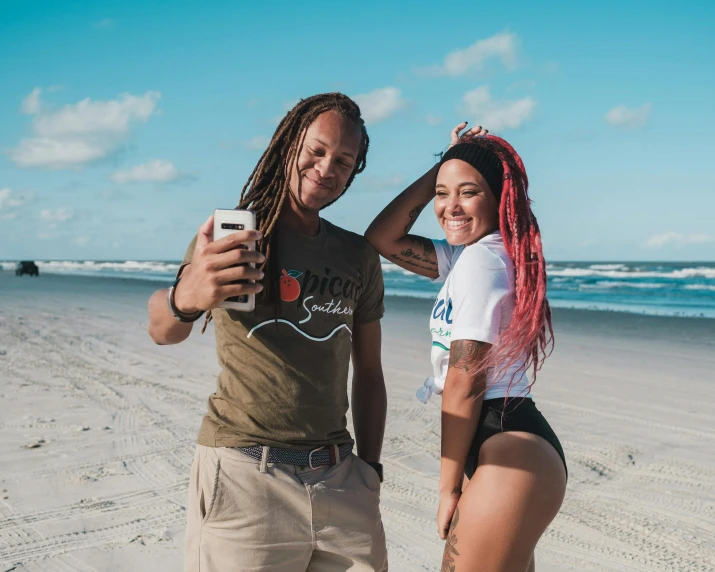 a man standing next to a woman on a beach, a polaroid photo, pexels contest winner, graffiti, trippie redd, dreadlock breed hair, tiktok video, smooth models