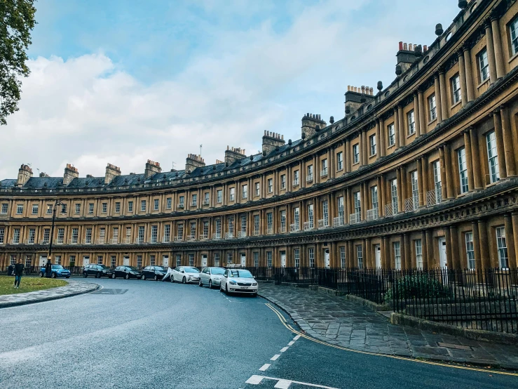 a row of buildings sitting on the side of a road, by Rachel Reckitt, unsplash contest winner, neoclassicism, bathed in light, square, terraced, slide show