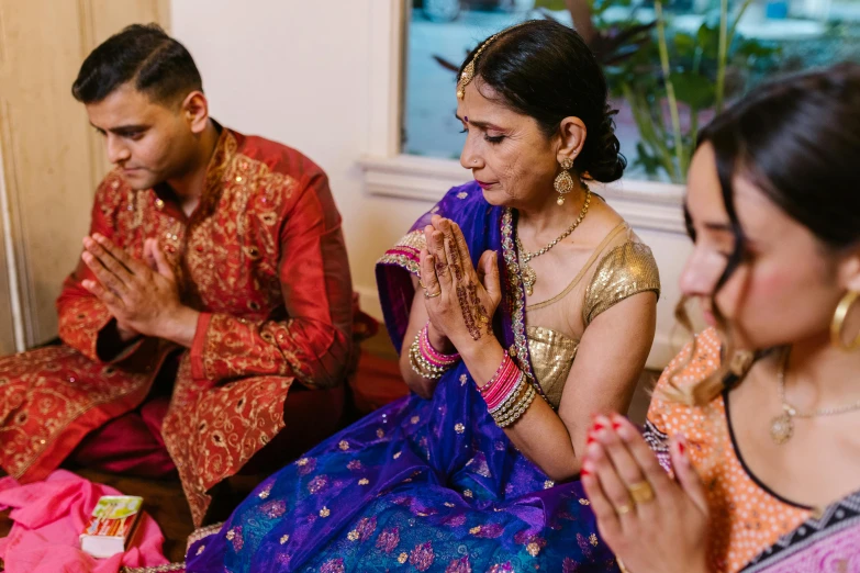 a group of people sitting next to each other, hindu ornaments, bay area, profile image, fan favorite