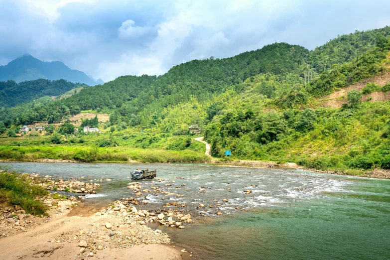 a boat traveling down a river next to a lush green hillside, by Daren Bader, pexels contest winner, hurufiyya, vietnam, panoramic, rapids, slide show