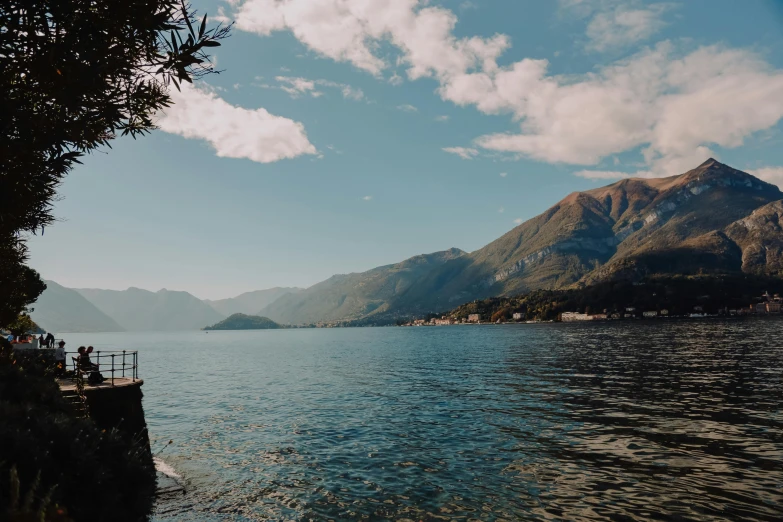 a body of water with mountains in the background, by Julia Pishtar, pexels contest winner, vouge italy, boka, al fresco, thumbnail