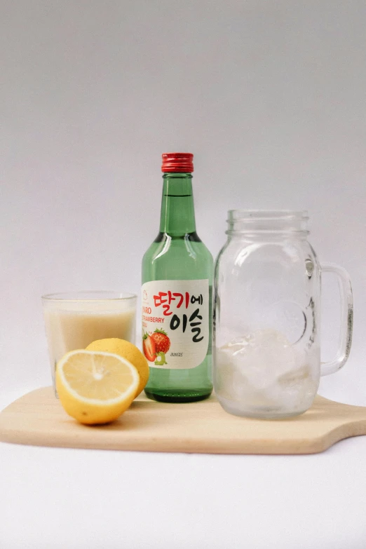 a bottle of water and a glass of lemonade on a cutting board, inspired by Kim Jeong-hui, cream white background, korean supper, cider-man, yogurt