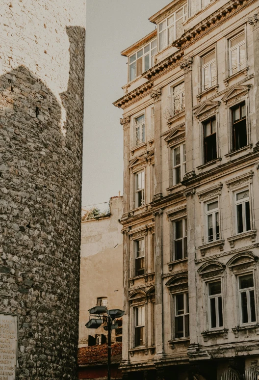 a couple of buildings that are next to each other, a photo, pexels contest winner, renaissance, stone facade, split near the left, 2019 trending photo, high walls