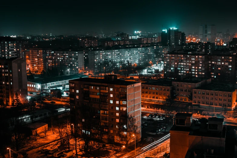 an aerial view of a city at night, by Adam Marczyński, pexels contest winner, brutalism, soviet suburbs, orange and cyan lighting, фото девушка курит, city on the background