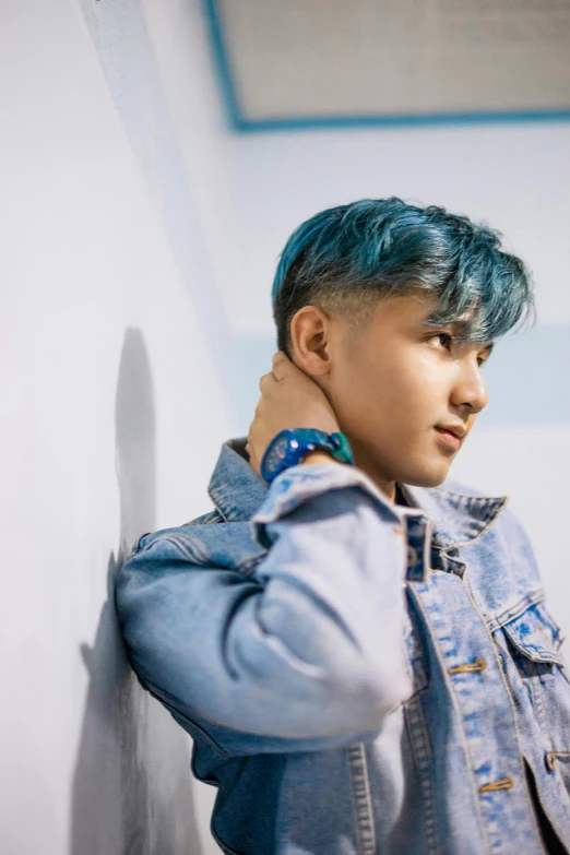 a man with blue hair leaning against a wall, inspired by jeonseok lee, trending on pexels, generic kpop boy band, concert, profile image, non-binary