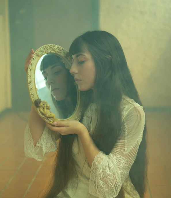 a woman holding a mirror in front of her face, an album cover, inspired by Elsa Bleda, pexels contest winner, art nouveau, melanie martinez, medium format. soft light, ((portrait)), first aid kit