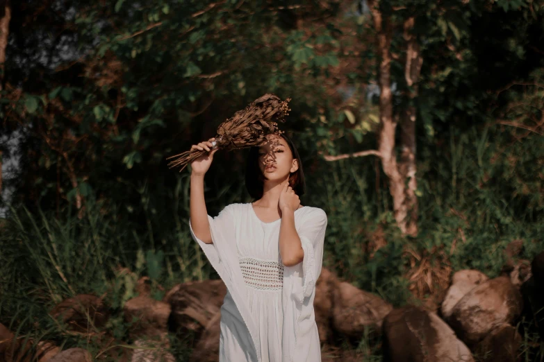 a woman in a white dress holding a bird on her head, an album cover, pexels contest winner, in the jungle. bloom, indian girl with brown skin, photoshoot for skincare brand, profile pic