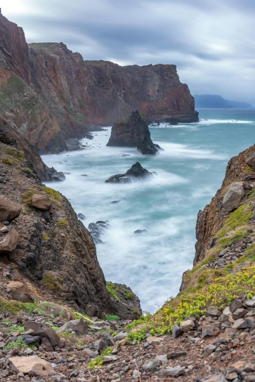 a rocky cliff overlooks the ocean on a cloudy day, by Hallsteinn Sigurðsson, majestic spires, portugal, gigapixel photo