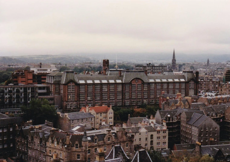 a view of a city from the top of a building, inspired by Thomas Struth, unsplash, art nouveau, edinburgh castle, 1990s photograph