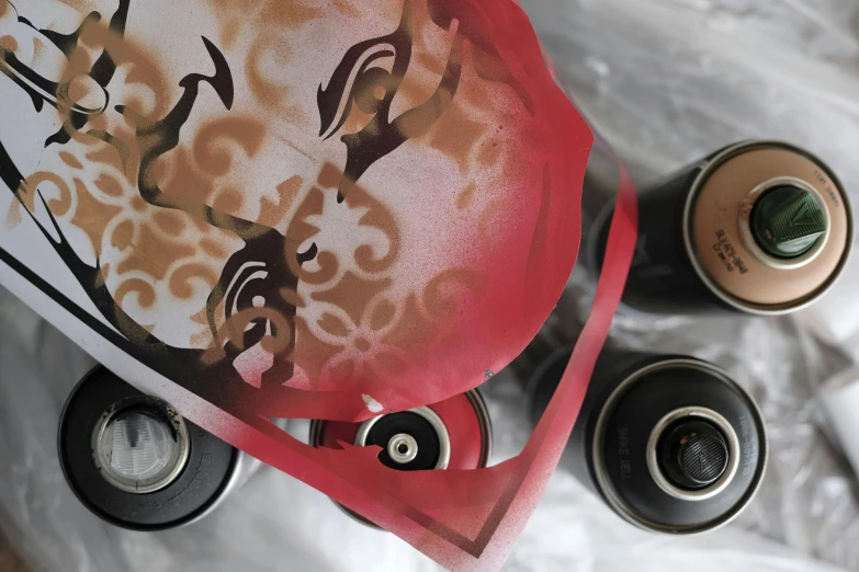 a couple of bottles sitting on top of a table, an airbrush painting, inspired by James Rosenquist, unsplash, graffiti, bandanas, high angle close up shot, samurai vinyl wrap, shot from below