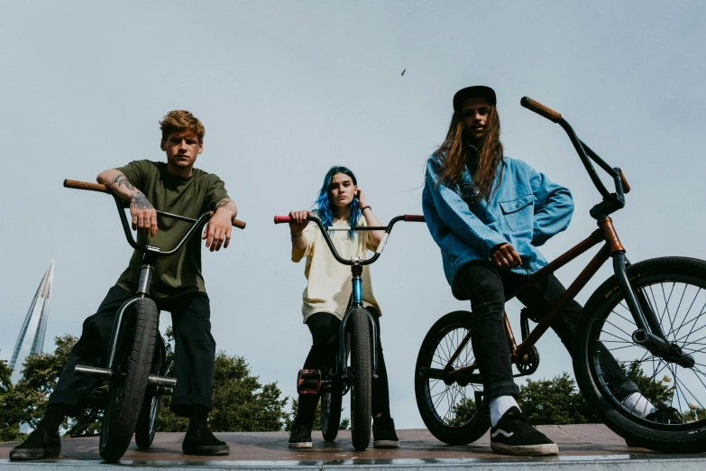 a group of people standing next to each other on bikes, an album cover, by Cam Sykes, pexels contest winner, realism, skatepark, witchcore, profile image, julia hetta