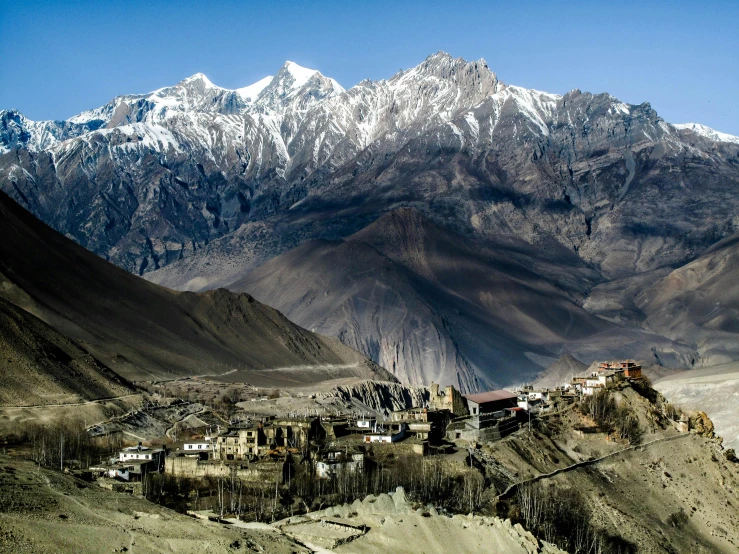 a small village in the middle of a mountain range, by Peter Churcher, pexels contest winner, hurufiyya, buddhist, snow capped mountains, 2000s photo, high quality image”