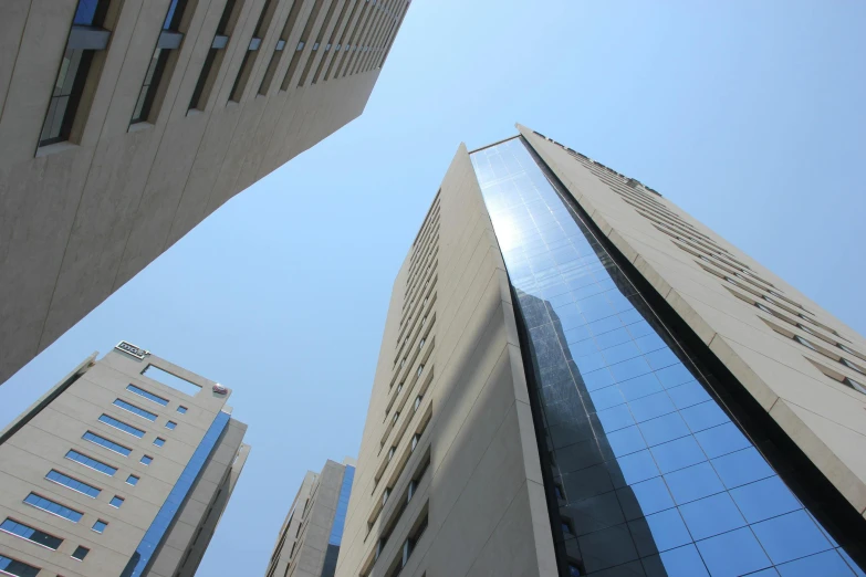 a couple of tall buildings next to each other, gutai group, picture taken from the ground, kyza saleem, exterior photo, three - quarter view