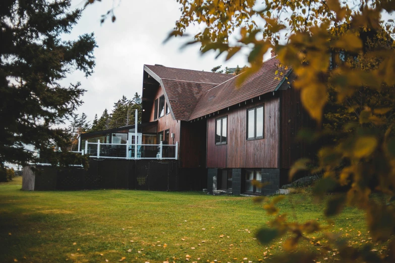 a house sitting on top of a lush green field, pexels contest winner, modernism, autumnal, alaska, view from ground level, profile image