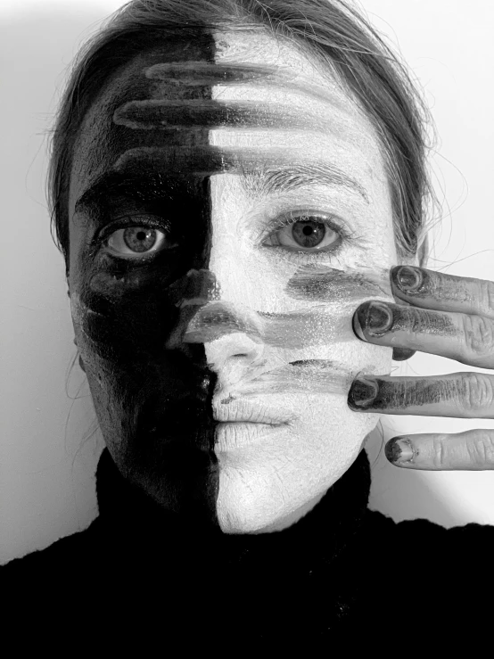 a black and white photo of a woman with her hands on her face, a black and white photo, by Maksymilian Gierymski, hyperrealism, facepaint facepaint facepaint, image split in half, half and half, black mask