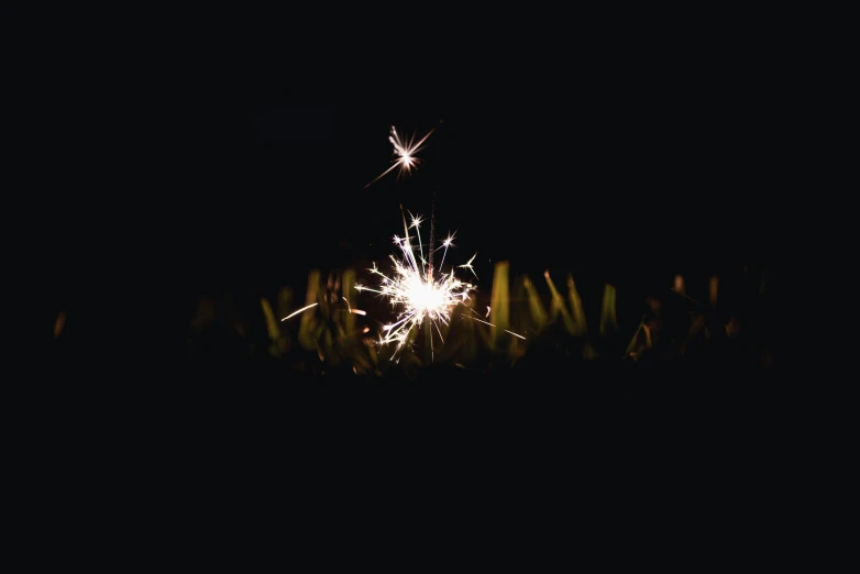 a sparkler is lit up in the dark, unsplash, sequins, ilustration, digital image, delightful surroundings