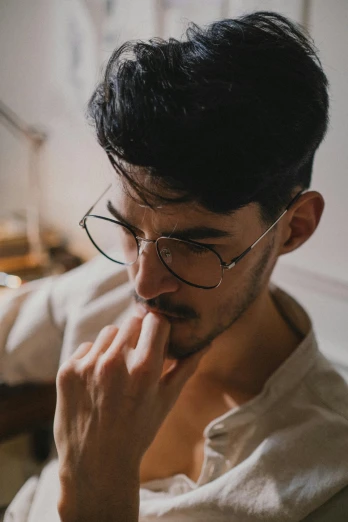 a man sitting in front of a laptop computer, a character portrait, trending on pexels, renaissance, jewish young man with glasses, seductive stare, alessio albi and shin jeongho, square masculine jaw