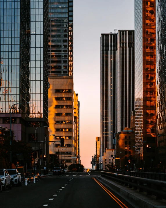 a city street filled with lots of tall buildings, unsplash contest winner, modernism, golden hour 8k, glass and steel, japanese downtown, taken in the late 2010s