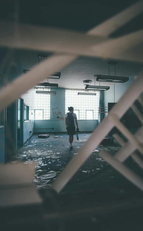 a person walking through a building under construction, inspired by Elsa Bleda, unsplash contest winner, happening, inside a decayed hospital room, holding a staff, inside elementary school, 15081959 21121991 01012000 4k