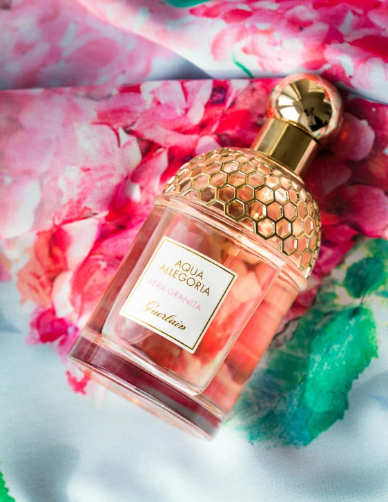 a close up of a bottle of perfume on a bed, by Julia Pishtar, rococo, pink and gold, honeycomb halls, thumbnail, arabella mistsplitter