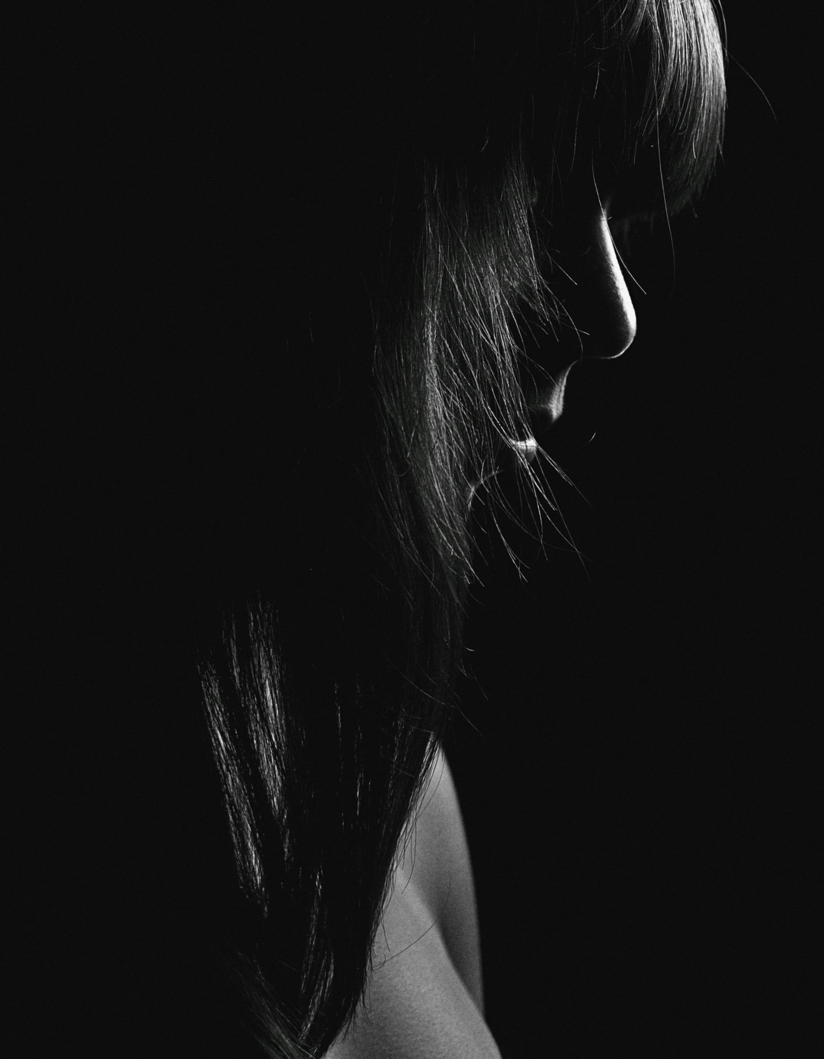 a black and white photo of a woman with long hair, pexels contest winner, darkness. dark, profile image, girl with black hair, with a hurt expression