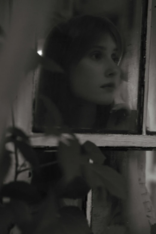 a black and white photo of a woman looking in a mirror, inspired by Sergio Larraín, jenna coleman, seen through a window, still from a music video, promo image