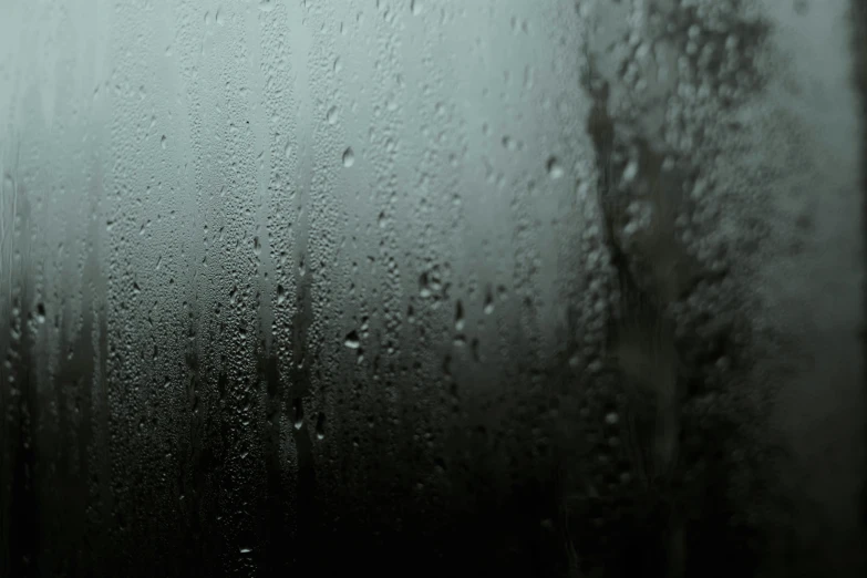 a close up of a window with rain on it, pexels, tonalism, background image, black-water-background, cold atmosphere, slick wet walls