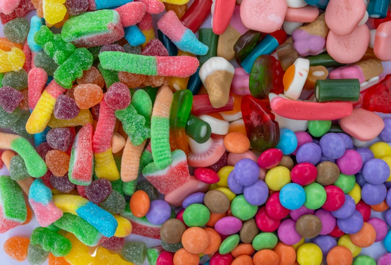 a pile of candy sitting on top of a table, microorganisms, highly upvoted, different sizes, cavities