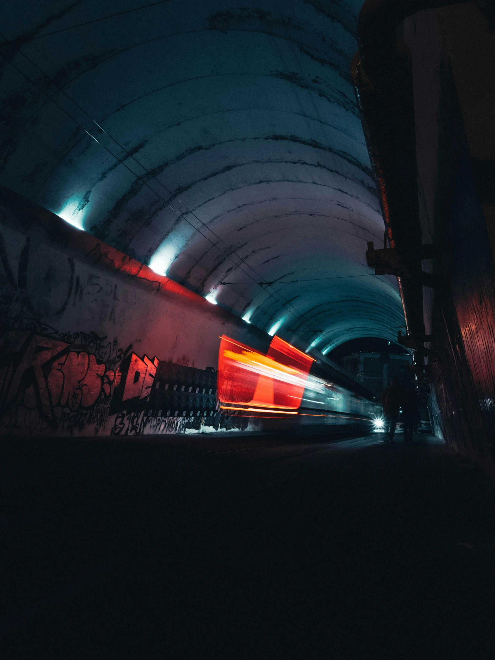 a train traveling through a tunnel at night, inspired by Elsa Bleda, unsplash contest winner, graffiti, flashy red lights, trending on vsco, inside a brutalist space ship, overexposed photograph