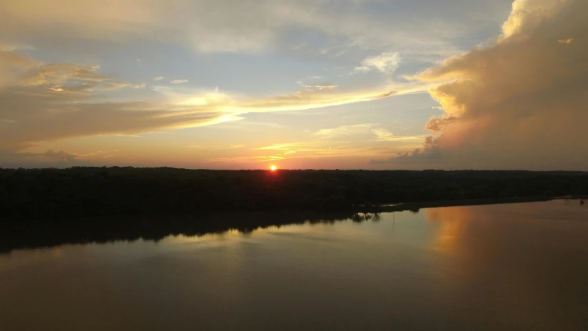 the sun is setting over a body of water, a picture, pexels contest winner, red river, slide show, view from high, reflection