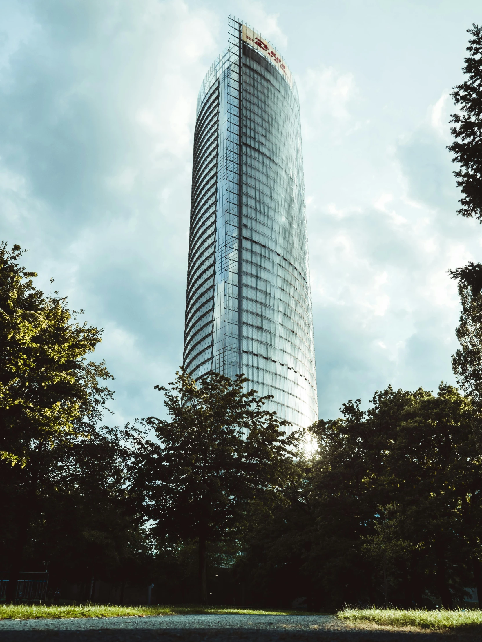 a tall building sitting on top of a lush green field, unsplash contest winner, hurufiyya, warsaw, in style of norman foster, city of munich!!!, portrait photo