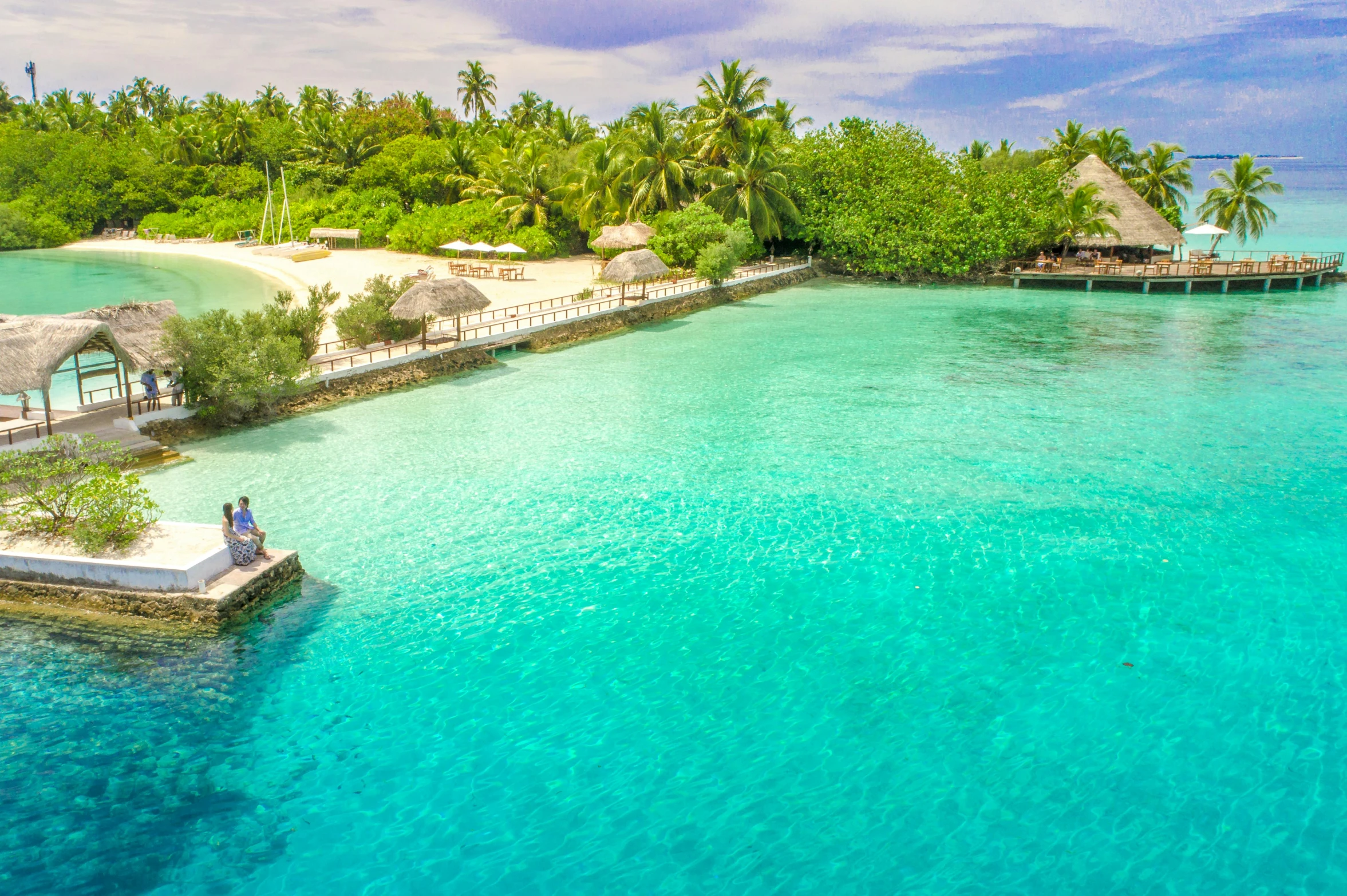 a tropical island in the middle of the ocean, pexels contest winner, hurufiyya, light blue water, family friendly, near a jetty, birdeye