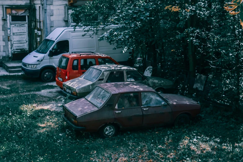 a couple of cars that are parked in the grass, inspired by Elsa Bleda, pexels contest winner, auto-destructive art, post - soviet courtyard, ghetto, 3 heads, anton migulko