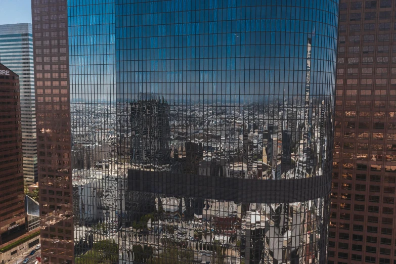 a very tall building sitting in the middle of a city, 4k photo gigapixel, chile, window reflections, los angeles 2 0 1 5