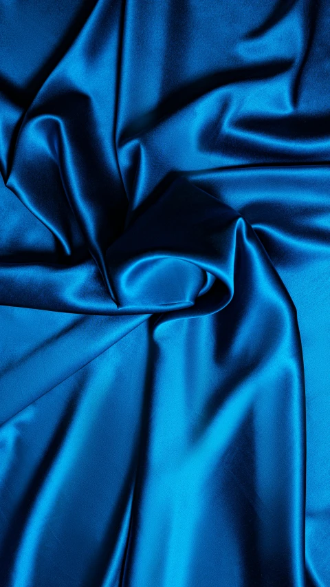 a close up of a blue satin fabric, inspired by Yves Klein, instagram, blue lighting, multicoloured, fabrics, blue backdrop