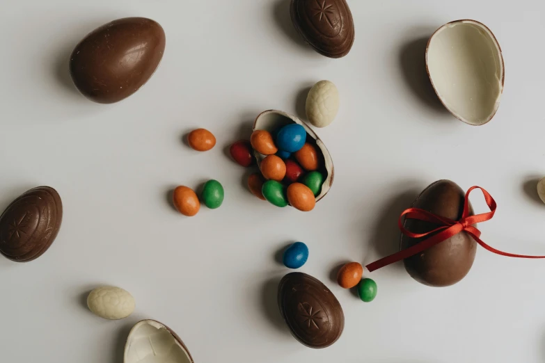 a bunch of chocolate eggs sitting on top of a table, inspired by Károly Patkó, pexels contest winner, flatlay, white background, various items, thumbnail