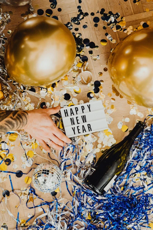 a person holding a sign that says happy new year, trending on pexels, happening, gold and cobalt tiles, champagne on the table, tattooed, thumbnail