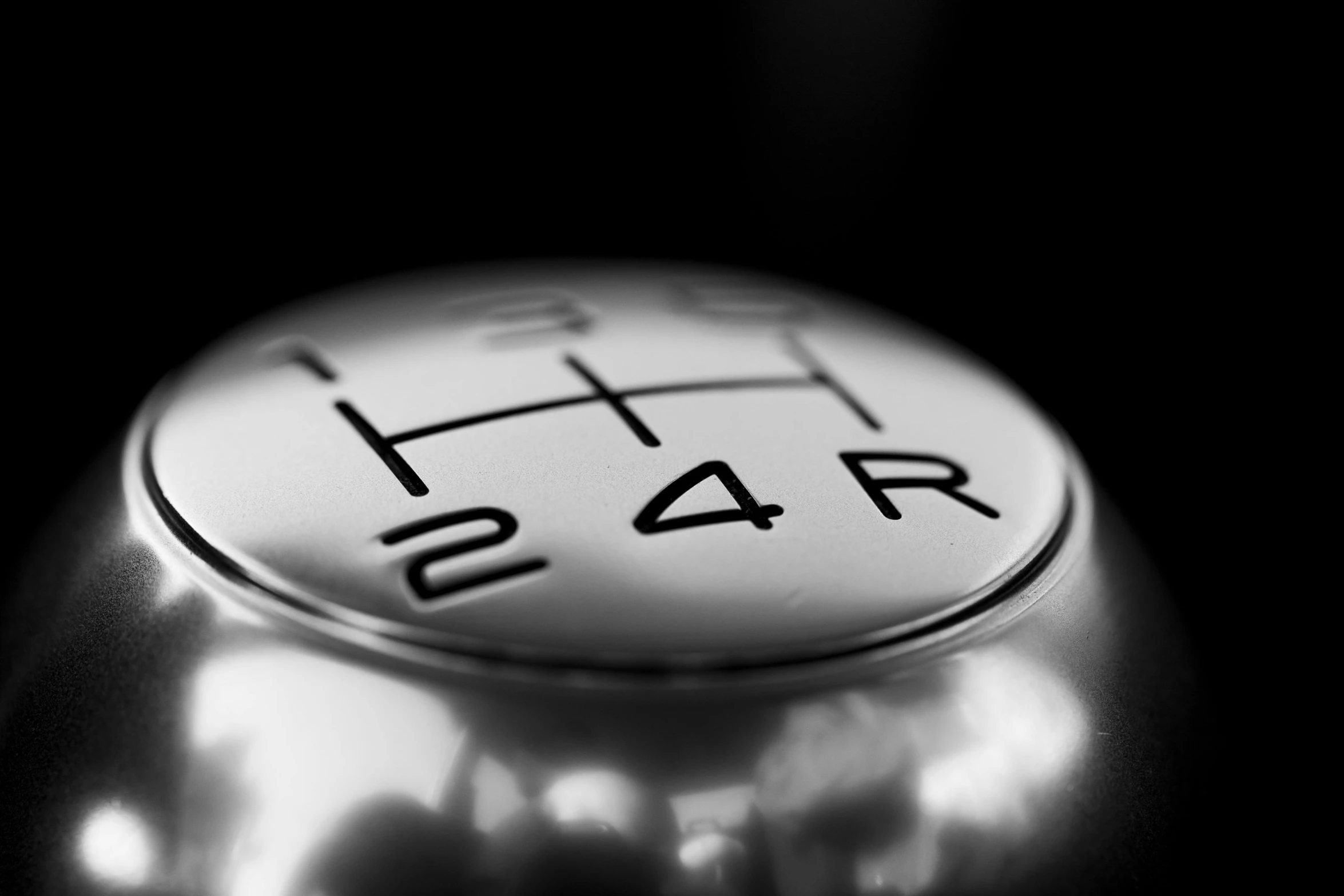 a close up of a metal gear knob, black-and-white, garner holt, realistic image, silver