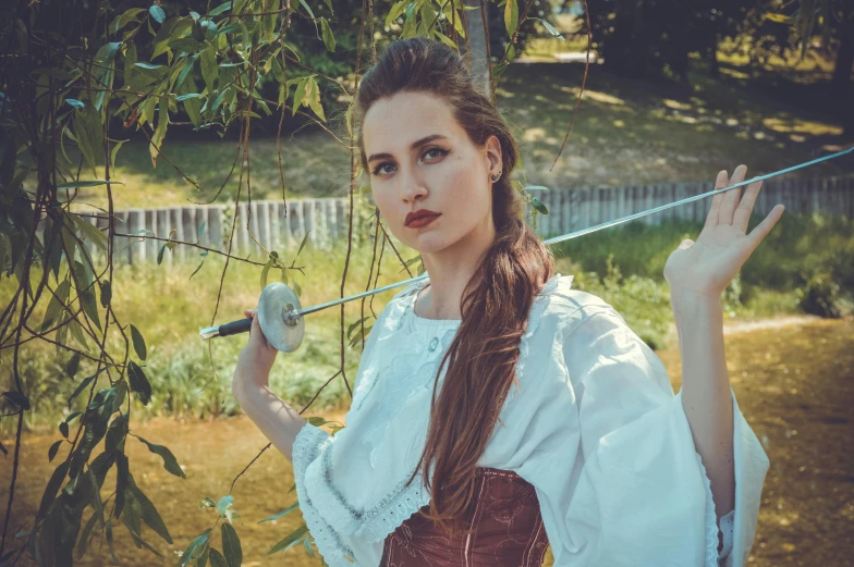 a woman dressed in medieval clothing holding a sword, inspired by Artemisia Gentileschi, pexels contest winner, in the garden, portrait sophie mudd, fencing, gil elvgren style