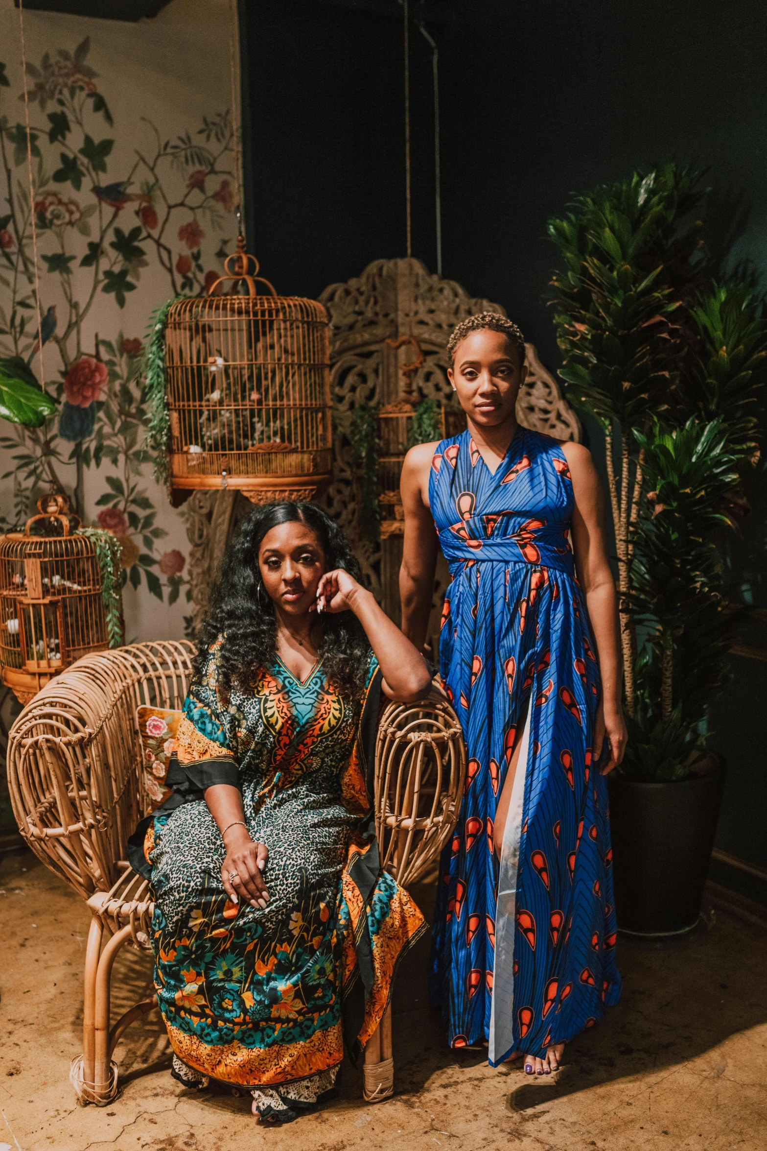 two women standing next to each other in a room, a portrait, inspired by Afewerk Tekle, pexels contest winner, renaissance, floral jungle treehouse, sitting down, official store photo, ethiopian