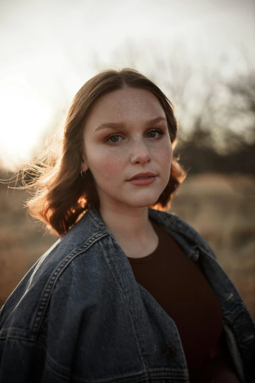 a woman standing in a field at sunset, unsplash, portrait of white teenage girl, detailed flawless face, mandy jurgens 8 k 1 5 0 mpx, portrait sophie mudd