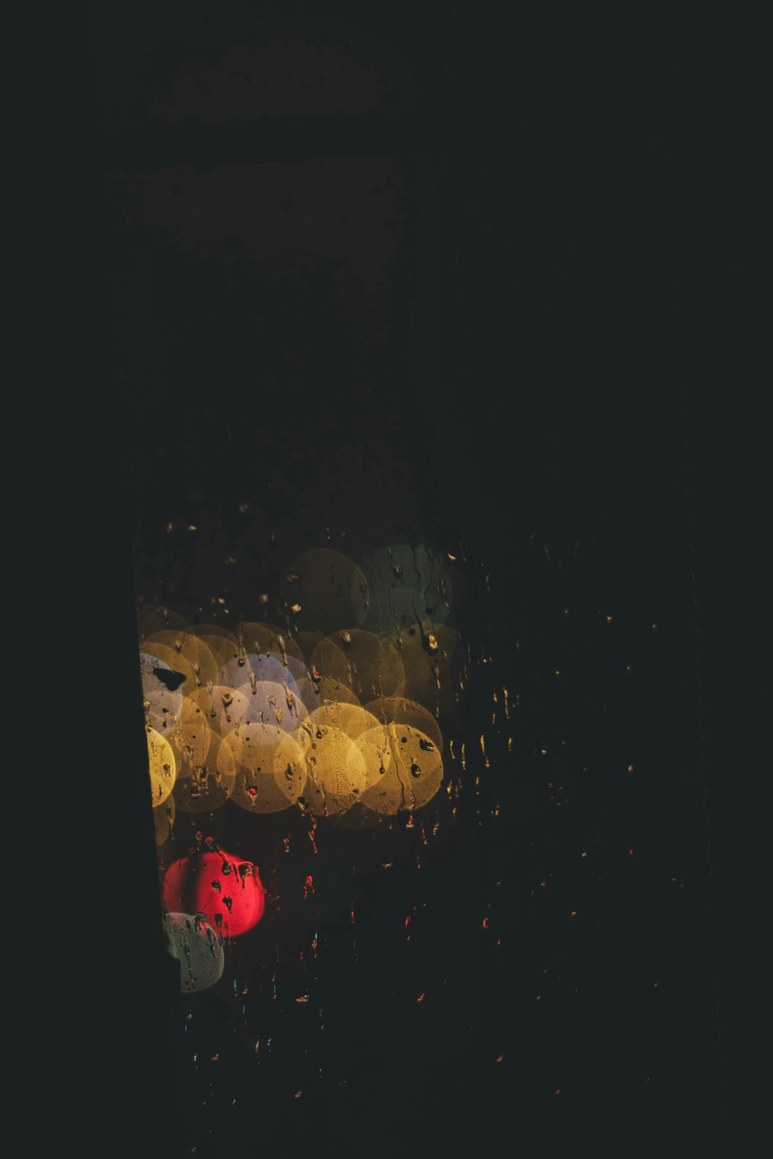 a street light is seen through a rainy window, an album cover, inspired by Elsa Bleda, unsplash, conceptual art, hanging out with orbs, red and yellow, dark. no text, dots abstract