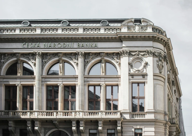 a large building with a clock on top of it, inspired by Károly Markó the Elder, neoclassicism, profile image, storefronts, set inside of the bank, brown