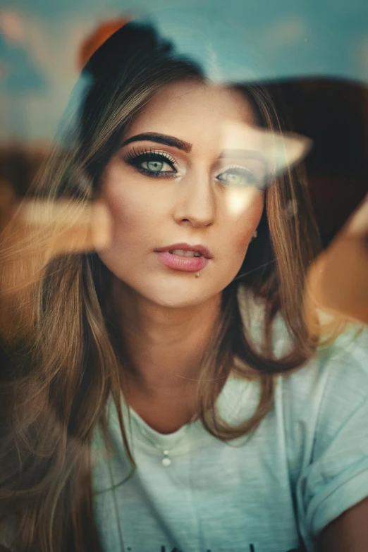 a beautiful young woman sitting in front of a window, a picture, by Adam Marczyński, trending on pexels, half face, reflective eyes, glossy eyes, extremely graphic