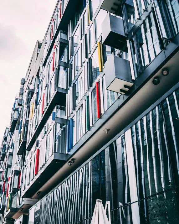 a very tall building with lots of windows, inspired by Bauhaus, pexels contest winner, colorful striped pavillions, thumbnail, apartment, shipping containers