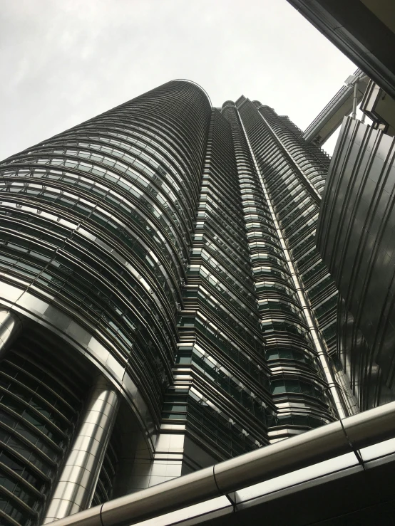 a very tall building with a lot of windows, inspired by Zaha Hadid, pexels contest winner, hyperrealism, malaysian, highly detailed # no filter, laquer and steel, tourist photo