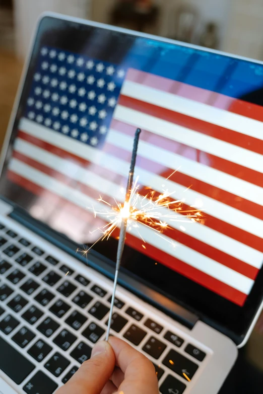 a person holding a sparkler in front of a laptop, american flags, 2 5 6 x 2 5 6 pixels, trending on markets, panel